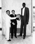 Mickey Leland posing with Manute Bol of the Golden State Warriors with other members by The Mickey Leland Papers & Collection Addendum. (Texas Southern University, 2018)